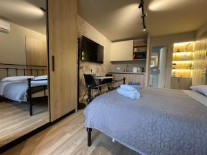 a bedroom with two beds and a table in it at Piazza Downtown Cozy Studio in Tirana +35 photos