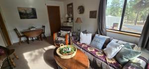 a living room with a couch and a table at Psycle Ranch Retreat in Durango