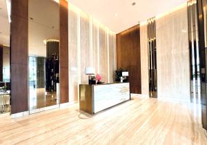 a lobby with a reception desk in a building at Signature 2BR Apartment ARC100 Vasa Suite Surabaya City Centre with Balcony by Le Ciel Hospitality in Surabaya +26 photos