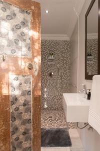 a bathroom with a shower and a sink at Mountain and Tides in Kleinmond +12 photos