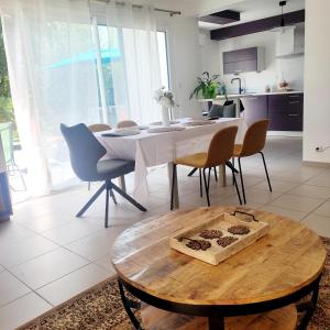 a kitchen and dining room with a table and chairs at Villa Cosy T5, Calme avec Jacuzzi XL in Nîmes