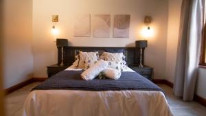 a bedroom with a bed with two pillows on it at Mountain and Tides in Kleinmond