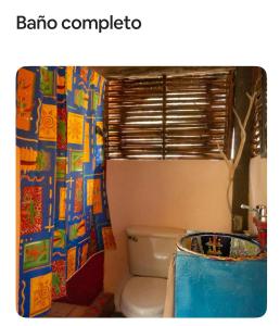 een badkamer met toilet en douchegordijn bij Casas Héctor Rios in Yelapa