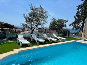 a swimming pool with lounge chairs and a swimming pool at House with ocean and mountain views in Santa Susanna