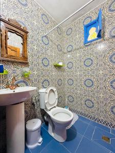 a bathroom with a toilet and a sink at Casa Blue Star in Chefchaouen +63 photos