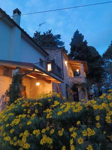 a house with yellow flowers in front of it at Casale del Tempo Lento in Narni
