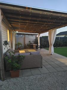 a covered patio with couches and a table at Casa Olas y Arena el Palmar in El Palmar