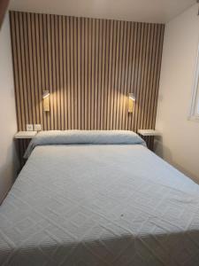 a bedroom with a large bed with two tables at Casa Olas y Arena el Palmar in El Palmar +11 photos