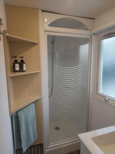 a shower with a glass door in a bathroom at Casa Olas y Arena el Palmar in El Palmar