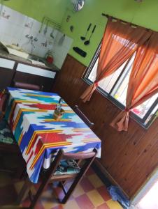 a room with a table with a colorful table cloth at Depto San Clemente del tuyu centro in San Clemente del Tuyú