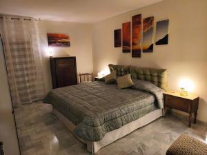 a bedroom with a bed and a table with lamps at Franca la Sarta House in Castellana Grotte
