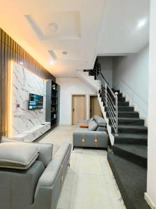 a living room with a couch and a staircase at 3-Bedroom fully serviced terrace in Orchid, Lekki Sig4 in Lekki