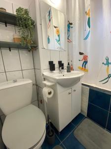 a bathroom with a white toilet and a sink at Straja Nest in Lupeni