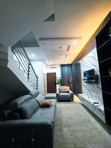 a living room with a couch and a staircase at 3-Bedroom fully serviced terrace in Orchid, Lekki Sig4 in Lekki