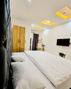 a bedroom with two beds and a flat screen tv at 3-Bedroom fully serviced terrace in Orchid, Lekki Sig4 in Lekki