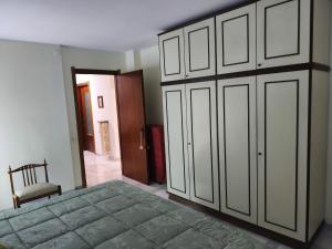 a bedroom with a large bed and a closet at Franca la Sarta House in Castellana Grotte