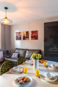 a living room with a table with plates of food on it at La maison de la mer in Criel-sur-Mer