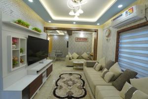 a living room with a couch and a tv at Changanassery in Changanācheri +25 photos