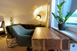 a living room with a wooden table and a couch at Apartment Manu in Inzlingen