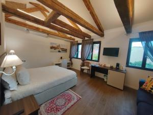 a bedroom with a bed and a desk and windows at Casa sulla Laguna CASTELLO in Venice