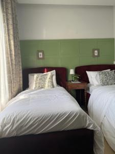 a bedroom with two beds and a window at The Libreville in Abuja