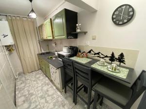 a kitchen with a counter and a clock on the wall at Straja Nest in Lupeni +24 photos