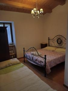 a bedroom with two beds and a chandelier at VILLA CLAUDI b&b in Camerino