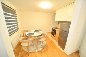 a small kitchen with a table and chairs in it at Vila Lepa in Užice