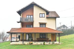 a house with a bench in front of it at Vila Lepa in Užice
