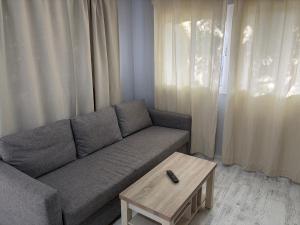 a living room with a couch and a coffee table at Casa Nueva in Las Palmas de Gran Canaria