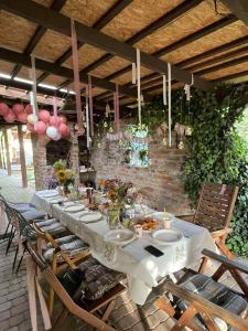 a long table with plates of food on it at Wolna Chwila in Maków