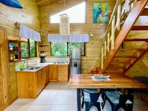 a kitchen with wooden walls and a wooden table at Finca Los Mangos in Manuel Antonio