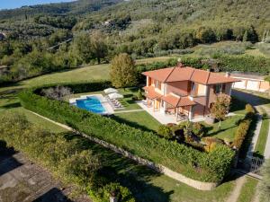 an aerial view of a house with a swimming pool at Villino Blu 12 pax villa in Tuscany with private pool in Loro Ciuffenna
