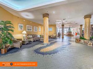 a lobby with columns and couches in a building at Amazing Studio Steps Away From The Atlantic Ocean! in Daytona Beach +40 photos