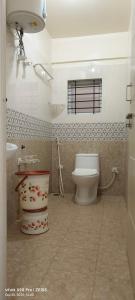 a bathroom with a toilet and a sink at Sgr Luxury Homes in Kammasandra +71 photos