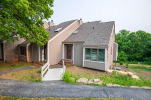 a house with a porch and a driveway at Hideaway Cove in Galena