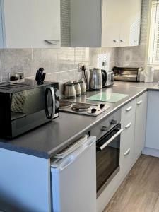 a kitchen with a counter top with a microwave at The Three bs in Scratby