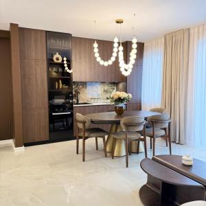 a kitchen and dining room with a table and chairs at Vanilla Studio Apartment 2 in Timişoara