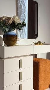 a white dresser with a tv on top of it at Vanilla Studio Apartment 2 in Timişoara