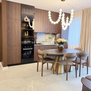 a kitchen with a dining room table and chairs at Vanilla Studio Apartment 2 in Timişoara +22 photos