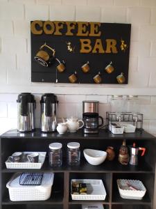 a shelf with a coffee bar sign on a wall at Homestay Tarapoto in San Antonio