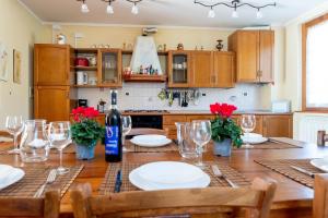 a kitchen with a wooden table with a bottle of wine at Villino Blu 12 pax villa in Tuscany with private pool in Loro Ciuffenna