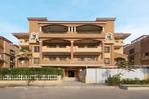 an apartment building with a fence in front of it at Luxurious 3Bd Hotel Apt in compound Sheikh Zayed with Pool and Gym access in Sheikh Zayed