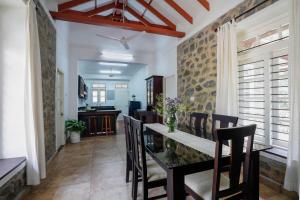 a dining room with a dining table and chairs at Ela Homes in Pala