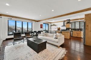a living room with a white couch and a kitchen at Wild Horse Meadows Eden Powder Mtn in Wolf Star