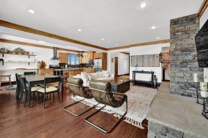 a living room with a couch and a stone fireplace at Wild Horse Meadows Eden Powder Mtn in Wolf Star