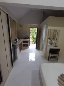 a room with a kitchen and a white floor at Lanta summer house nui bay in Ko Bu Bu