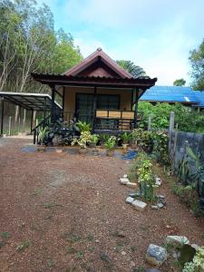 a house with a bench in front of it at Lanta summer house nui bay in Ko Bu Bu