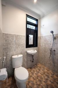 a bathroom with a toilet and a sink at Cahaya Adrian Near Komodo Airport in Labuan Bajo +26 photos