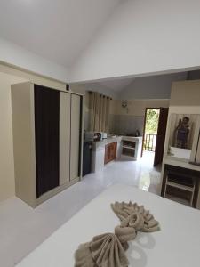 a kitchen with a white floor and a white counter top at Lanta summer house nui bay in Ko Bu Bu